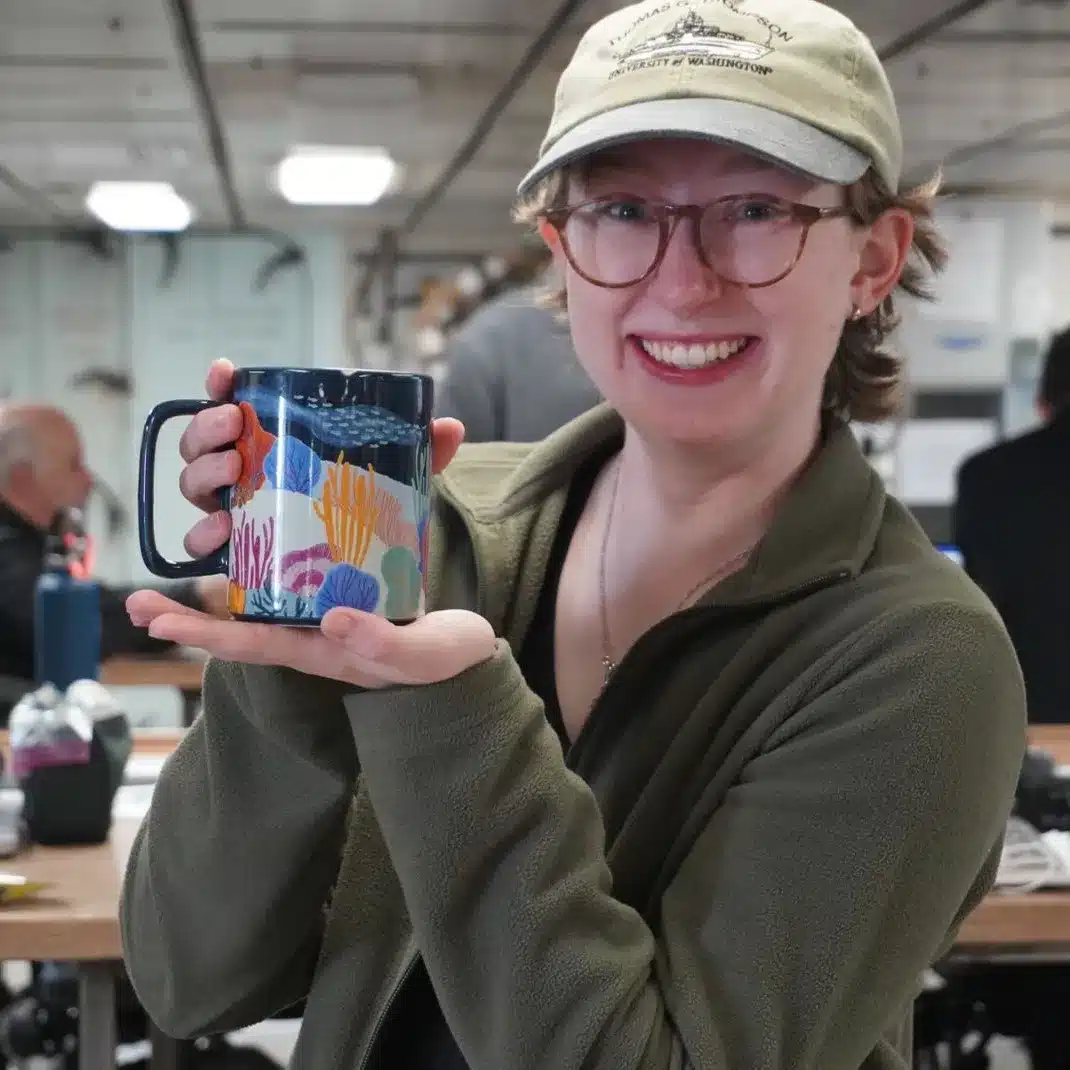 Emily Etheridge holding up a coffee mug