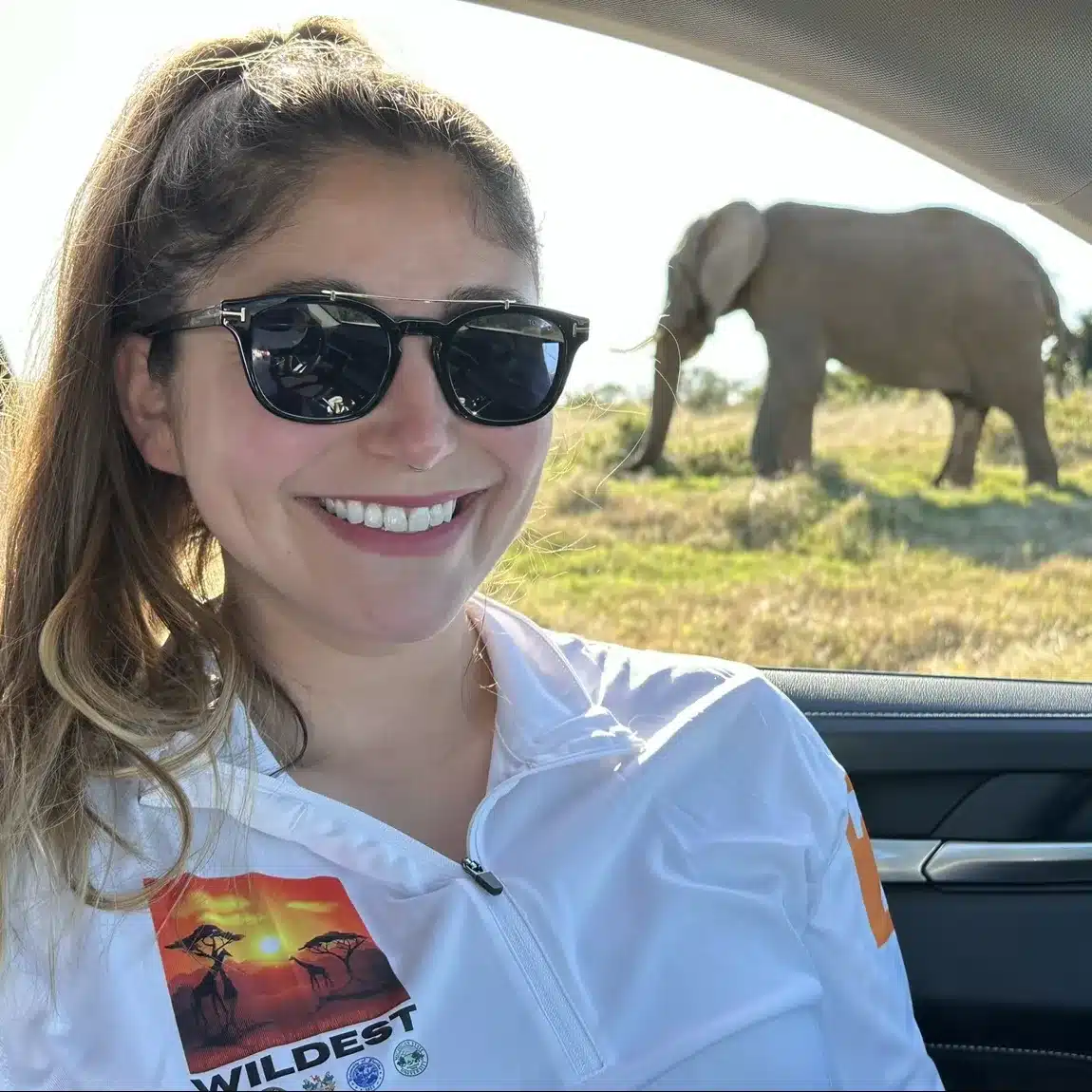 Hannah Herrero with an elephant in the background