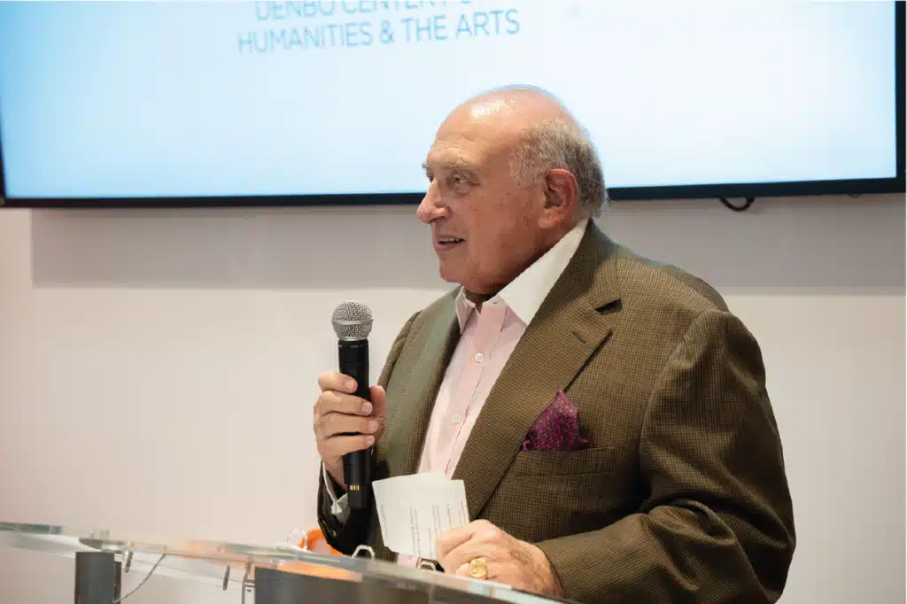 Photo of Don Denbo making a presentation at a glass podium