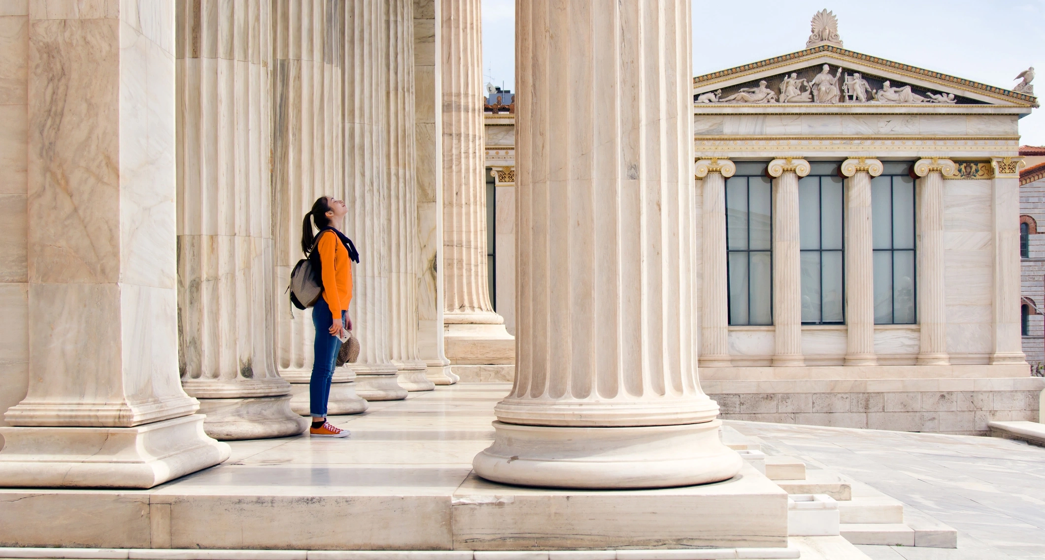 A student near Roman-style pillars