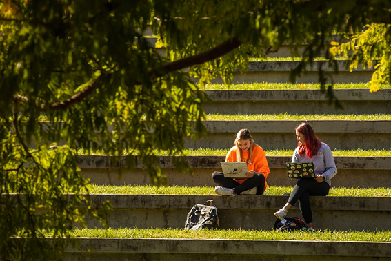 Two students studying in humanities plaza