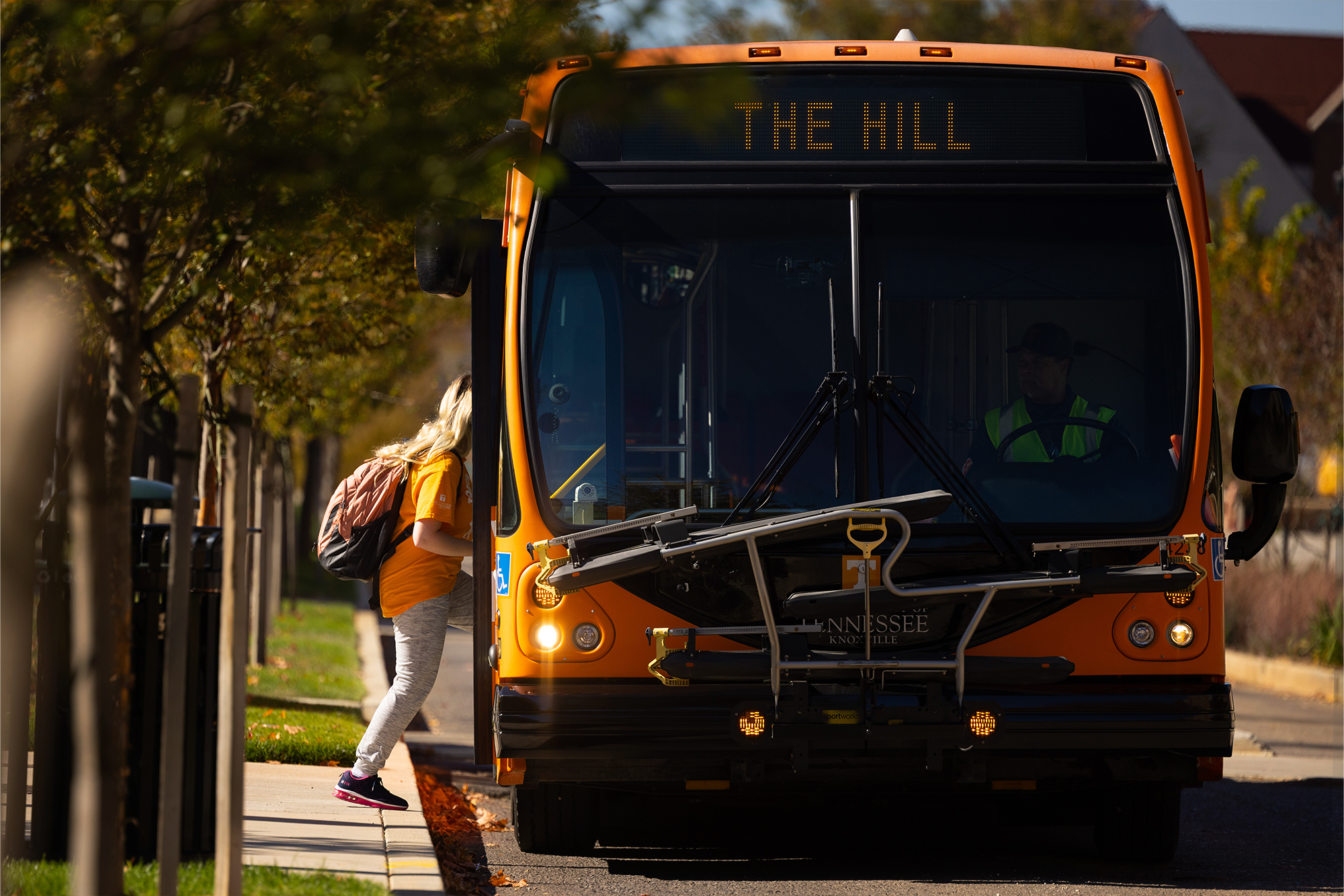 A student gets on the Ride the T bus