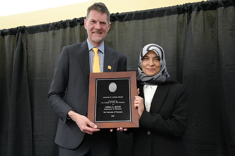 Nahla Hatab accepts an award from Robert Hinde at the Arts & Sciences Faculty Awards Ceremony in 2024