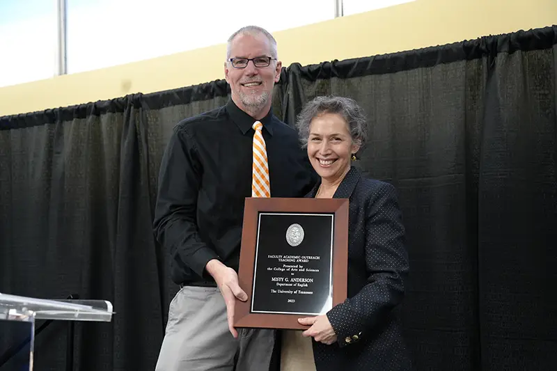 Misty Anderson accepts an award from Todd Moore at the Arts & Sciences Faculty Awards Ceremony in 2024
