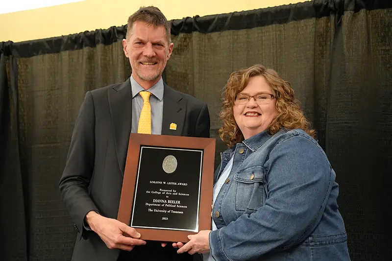 Dianna Beeler accepts an award from Robert Hinde at the Arts & Sciences Faculty Awards Ceremony in 2024