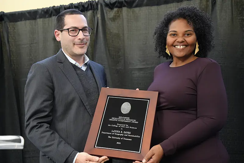 LaToya Eaves accepts an award from Michael Blum at the Arts & Sciences Faculty Awards Ceremony in 2024