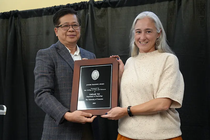 Caglar Tas accepts an award from Liem Tran at the Arts & Sciences Faculty Awards Ceremony in 2024