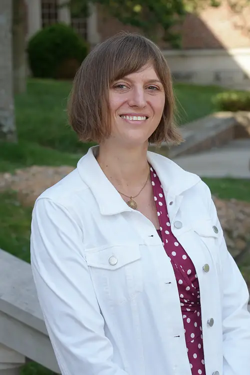 Professional Headshot of Beth Meko with Ayres Hall in the background