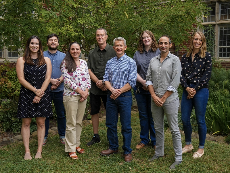 Outdoor group photo of eight faculty