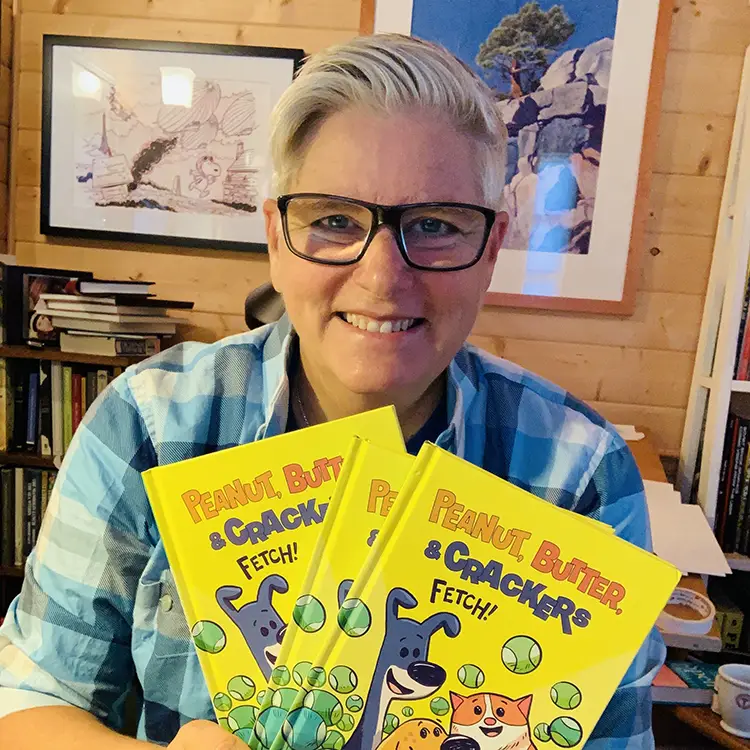 Photo of Paige Braddock holding three children's books