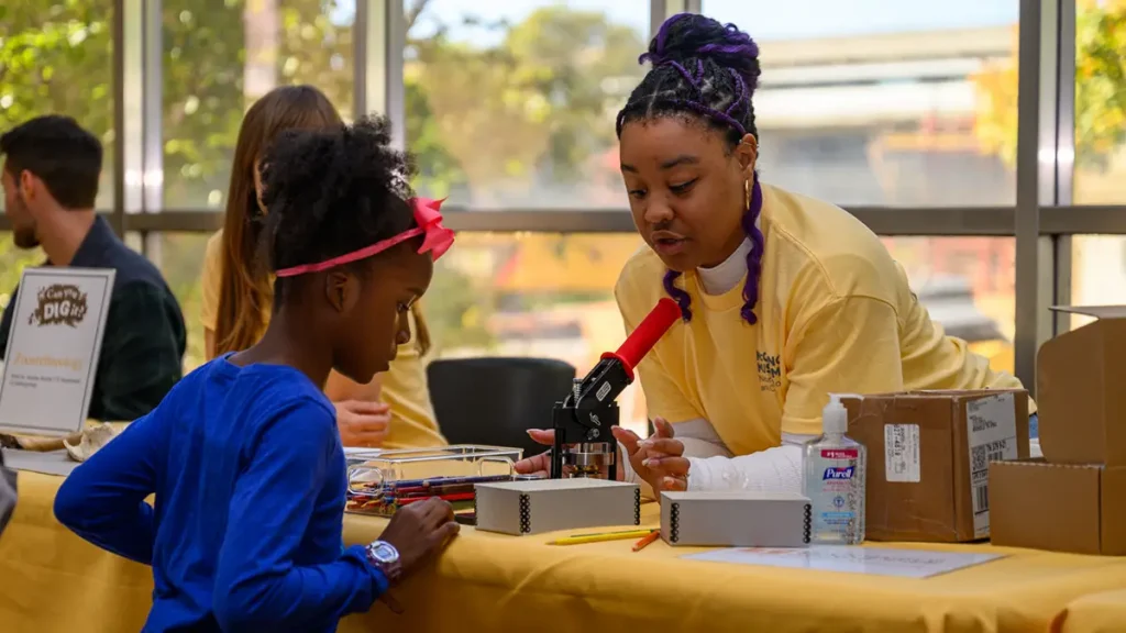 Student Mackenzie Pina hosts the zooarchaeology activity table. Photo by Grayson Photography.