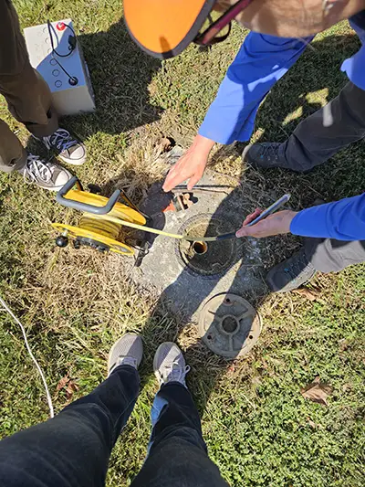 Students working with a water source at a dairy farm