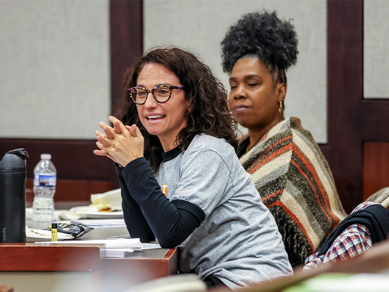 Two women listening to a presentation