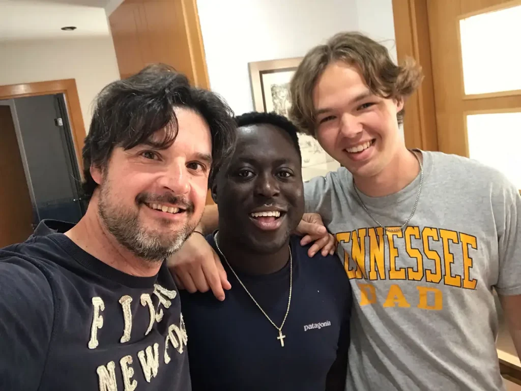 Three men taking a group photo