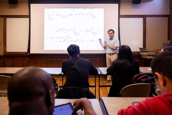 Tuoc Van Phan teaches Math 636 (Advanced Partial Differential Equations II) to graduate students inside an Ayres Hall classroom on February 09, 2023