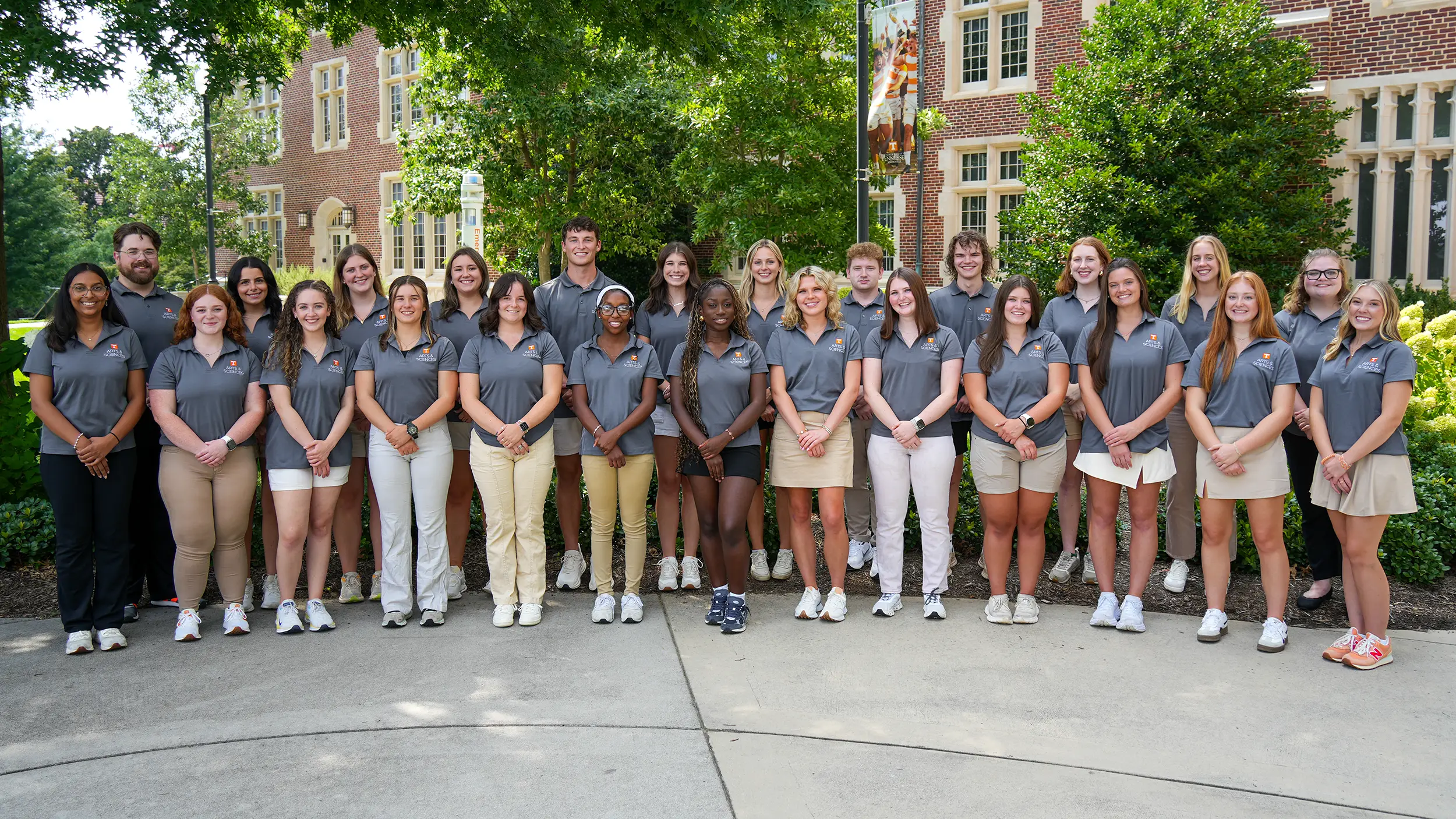 Student ambassadors stand in front of Ayres Hall. 