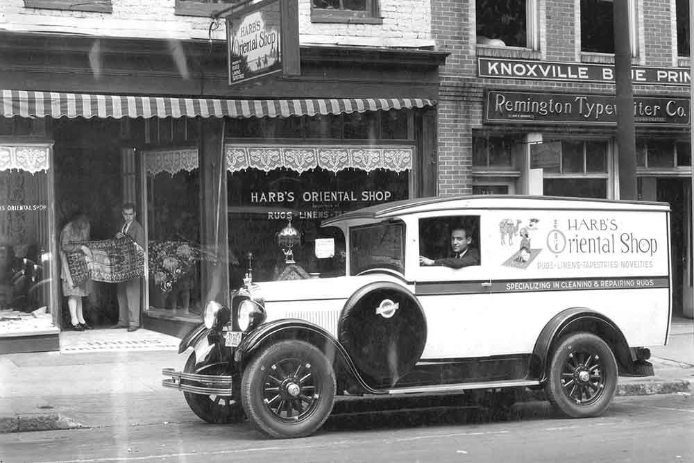 W.J. Harb and his brother John inside a vehicle outside their rug shop called "Harb's Oriental Shop"  in the 1920s. 