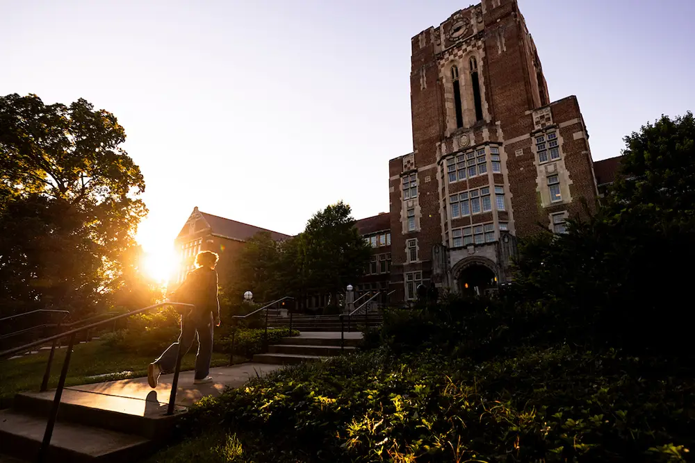 A student walks up The Hill with Ayres Hall in the background during a morning campus walk on August 27, 2025. 