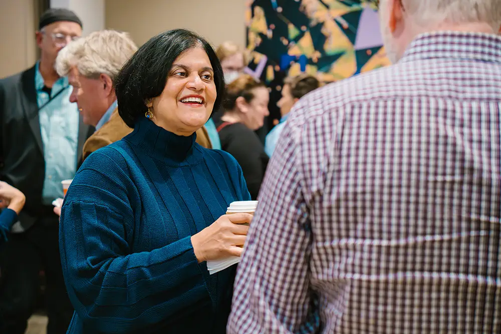 Distinguished Professor Urmila Seshagiri discusses her new publication The Life of Violet, with faculty colleagues during the fall book party.