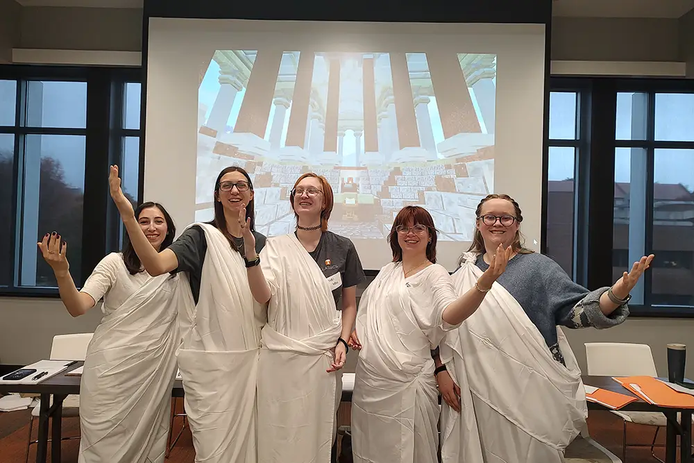 UT Classics Club organized a costume contest for the 2025 Latin Day where five UT students dressed as Latin senators. From left to right: Madeline Claire Delhomme, Lauren Wood, Virgil Voyles, Reese Reiley, and Cynthia Hazelton. 