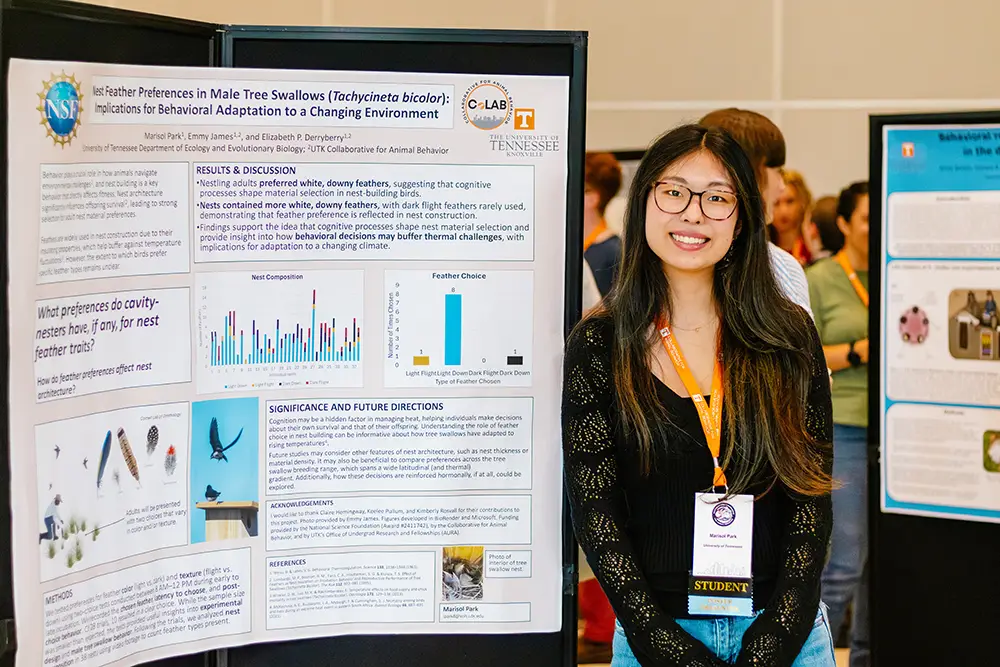 Marisol Park stands next to poster research presentation at the Southeastern Conference for Animal Behavior (SeCAB). 