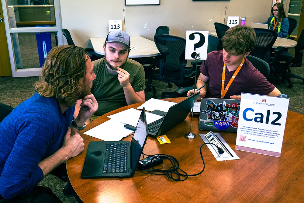 Two students receive help from a mathematics tutor at The Math Place on the second floor of Hodges Library.