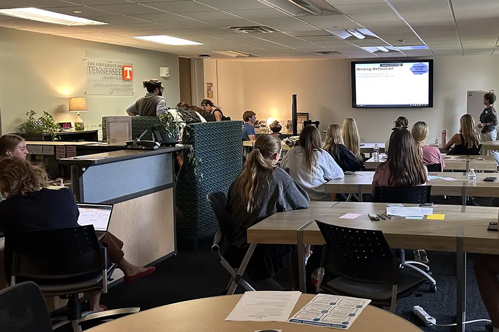 A group of students attend a workshop in the Herbert Writing Center.