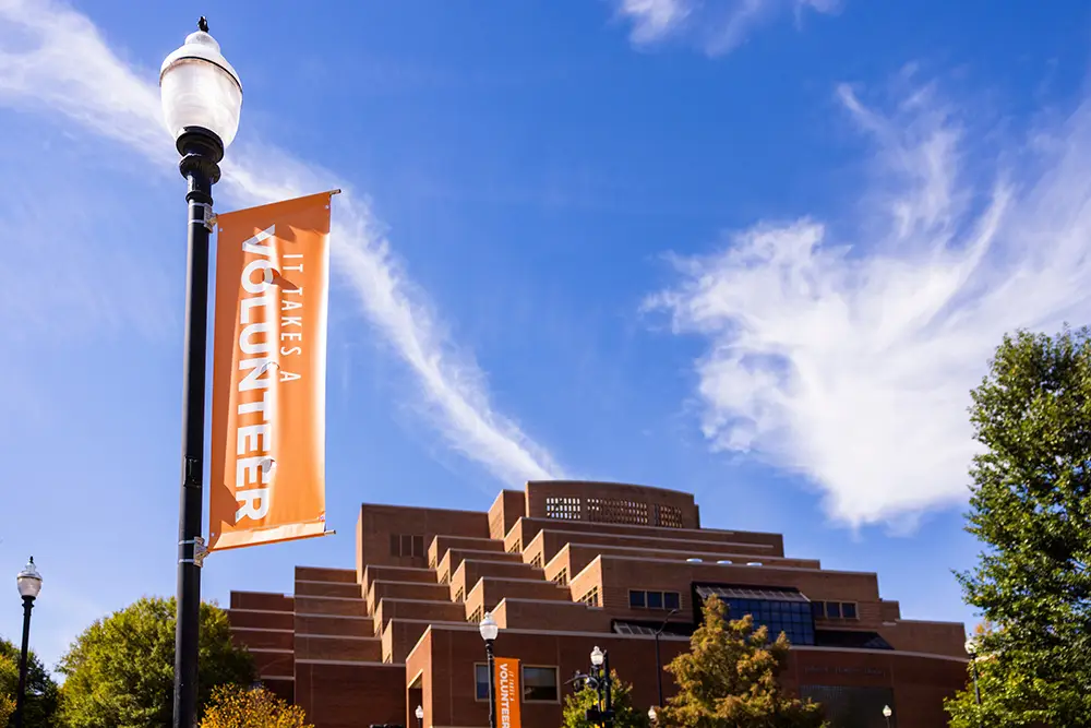 It Takes a Volunteer pole banners along Ped walkway with Hodges Library in the background on October 17, 2025.