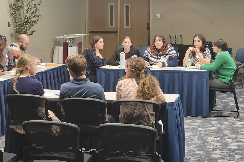 High School students sit at a table across from one another as they preset their cases during the 2026 High School Ethics Bowl, hosted by the UT Department of Philosophy.