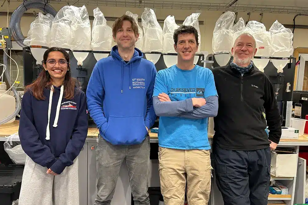 Jason Olavesen (second from left) stands with three other individuals in the molecular lab on RRS Sir David Attenborough ship. 