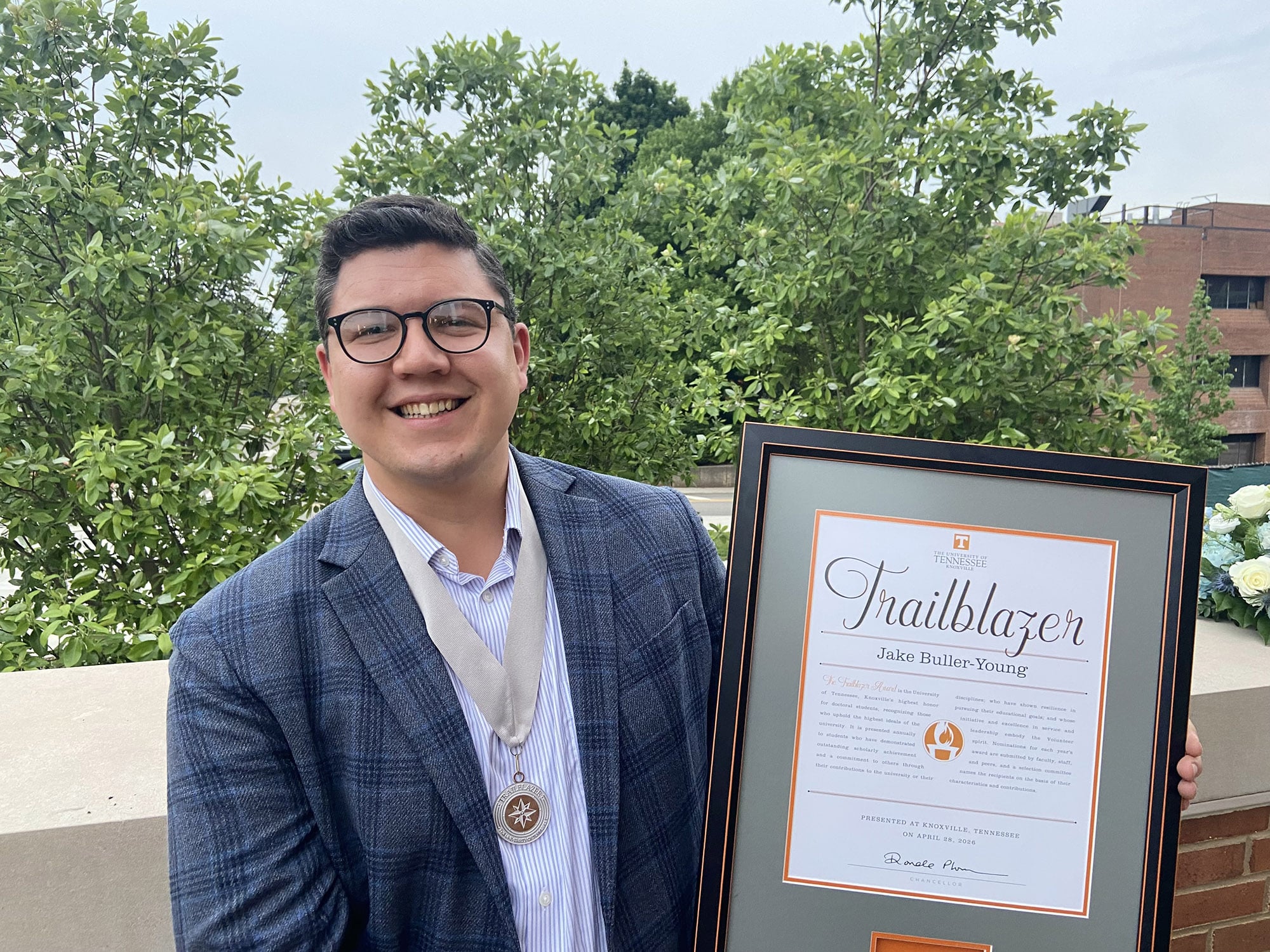 Jake Buller-Young holds his framed Trailblazer certificate.