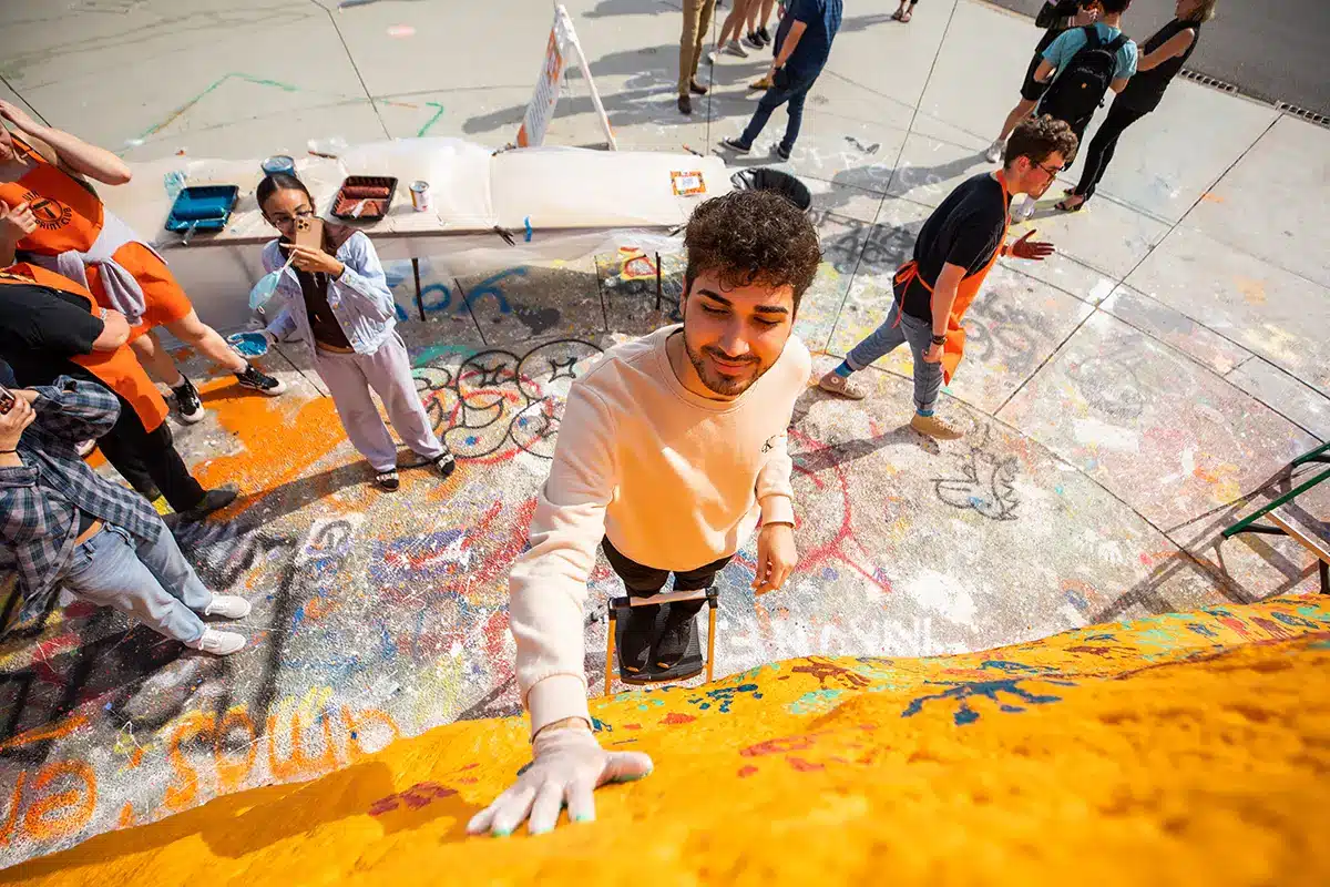 UT students put their painted handprints on the Unity Rock, a landmark on campus. 